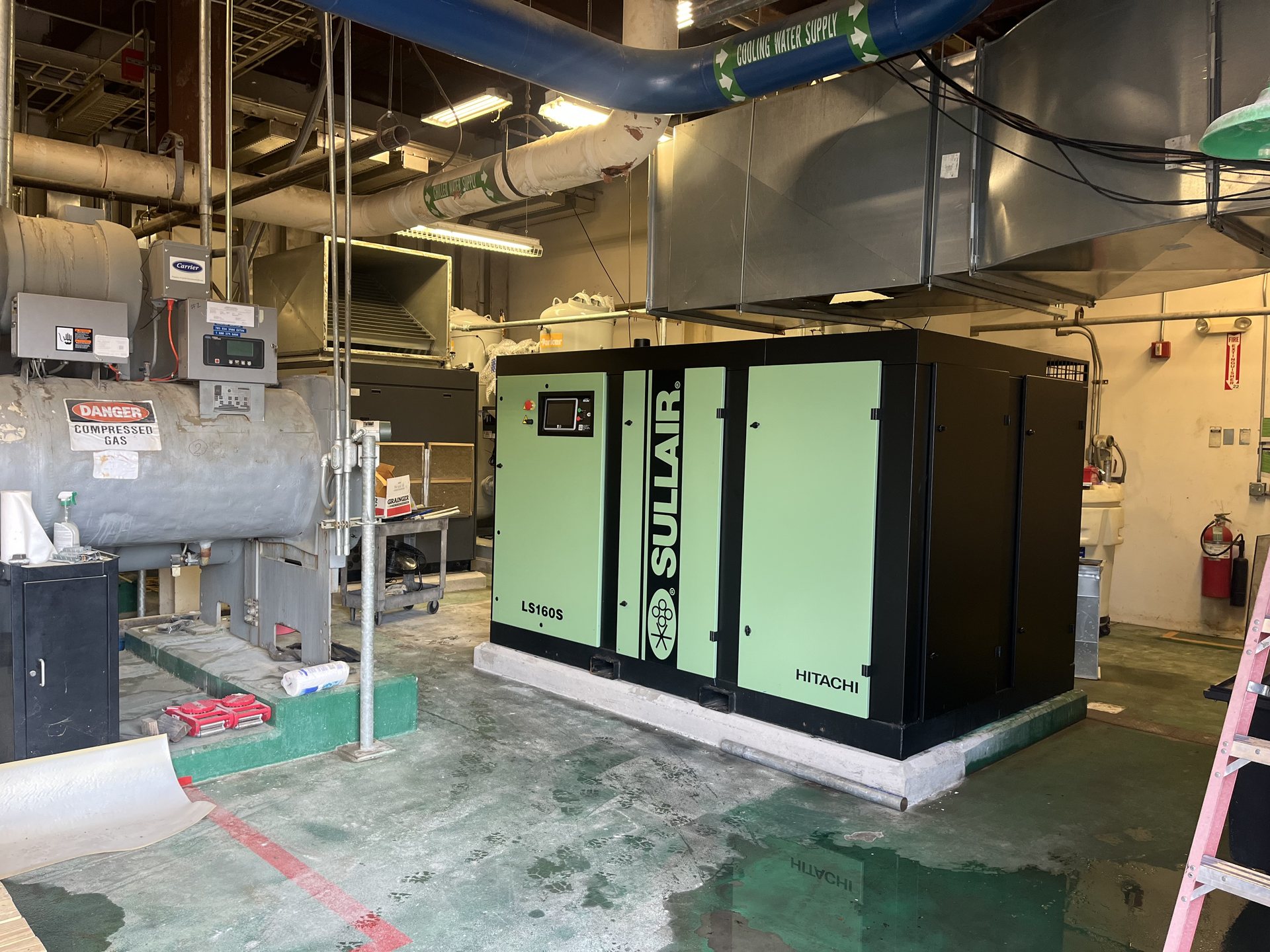 Air compressor set on a new grouted housekeeping pad in a Virginia facility