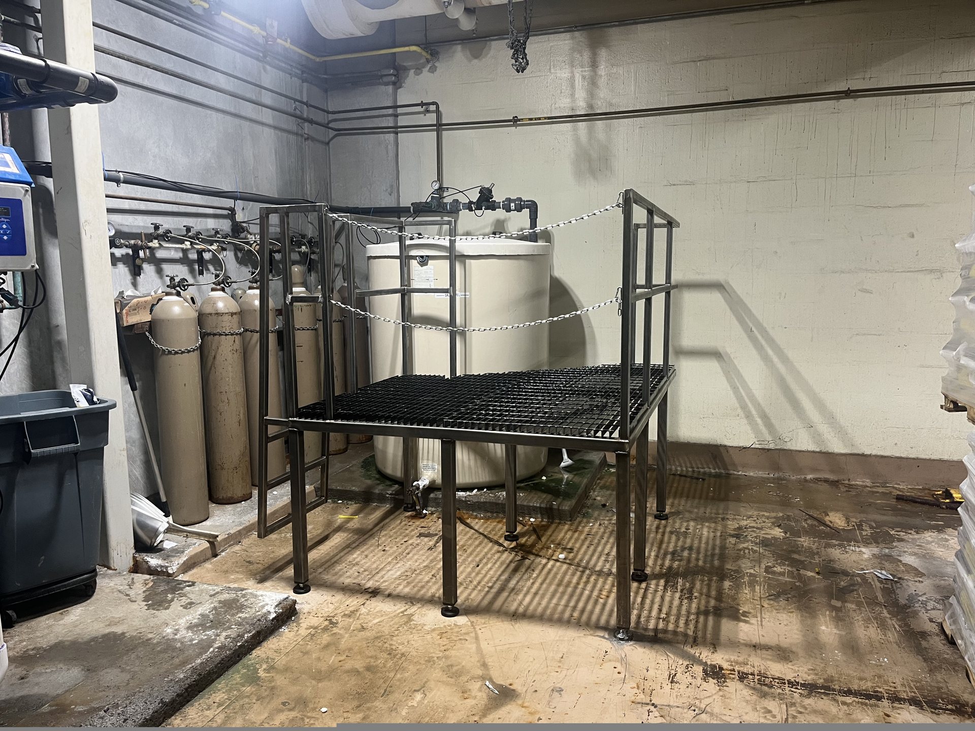 Fabricated stainless steel access platform with grating beside a chemical tank in Virginia